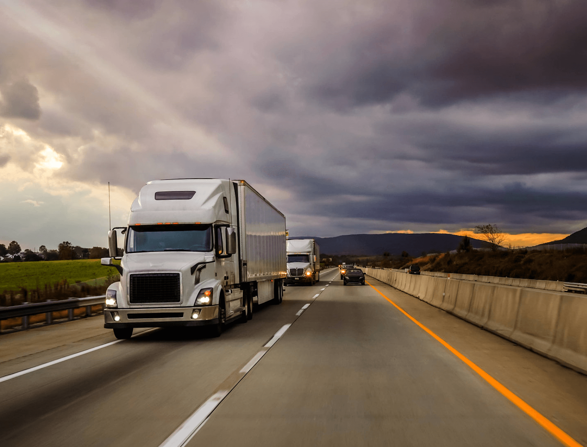 white trucks running on a highway
