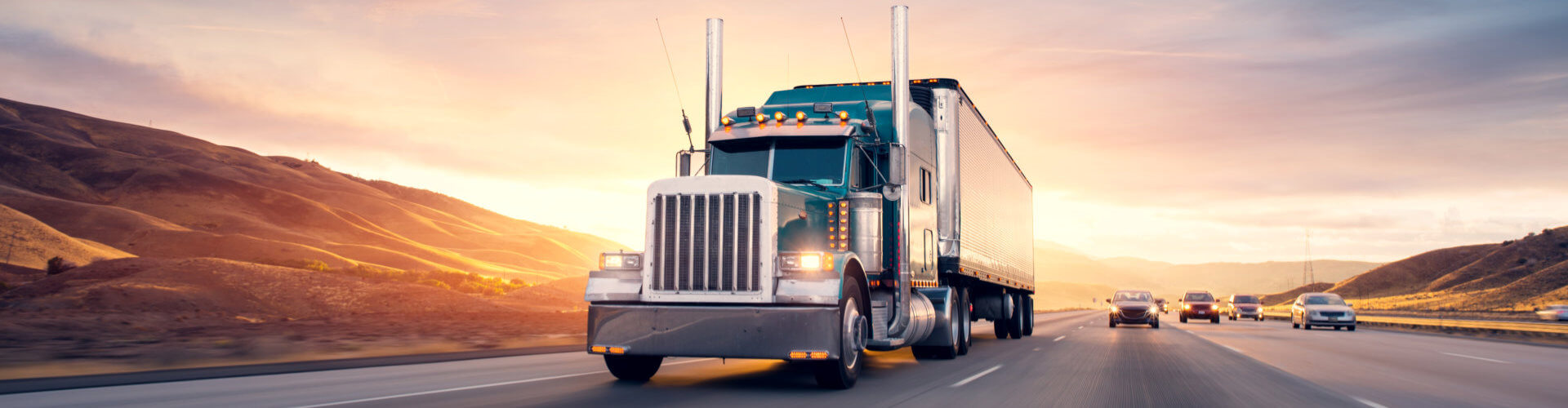 a truck running while the sun is setting down