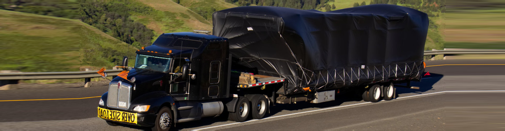 a black truck running on daytime